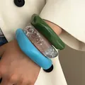 Close-up of thick resin bangles in green, blue, and silver foil on a person arm - 3-Piece Set Combination / Green, Transparent Blue And Sky Blue