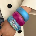 Close-up of three chunky resin bangles with glitter and pearl finish for women - 3-Piece Set Combination / Blue, Red And Glitter