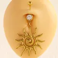 Close-up detail of a golden stainless steel sunburst belly ring with a vortex spiral center - Solar Swirl Pendant / Gold