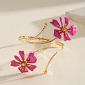 Detailed view of gold arm cuff featuring elegant pink enamel flowers and intricate petals. - Floral (HB5775) / Rose Red