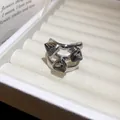 Detailed view of a vintage-style open ring with three triangular dark grey crystals. - Double Layer Hollow Triangle Style / Gray