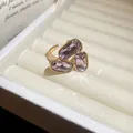 Close-up of vintage gold ring with three rectangular purple crystals in a gift box - Step Rectangle Style / Pink
