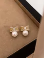 Elegant golden bowknot pearl stud earrings with sparkling crystal accents in a box - 18k Gold Plated Hollow Pearl Style