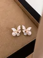 Elegant pink butterfly earrings featuring white pearls and sparkling crystal accents on gold - Pink Butterfly Pearl Style