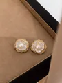 Elegant gold and silver flower stud earrings with center pearl in a jewelry box. - Hollow Double Layer Flower Style