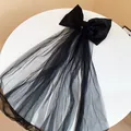 Elegant black fabric bow hair clip featuring a long flowing tulle veil detail for hair. - Duckbill Hair Clips / Black