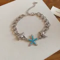 Detailed view of silver seashell and starfish bracelet with turquoise bead accents - 55# Bracelet / Silver-Blue