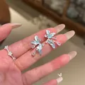 Close-up of elegant light blue flower butterfly earrings with shimmering zircon drops - Butterfly Floral Pendant (5#) / Silver-Blue