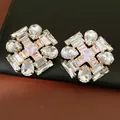 Close-up detail of geometric stud earrings with sparkling teardrop and rectangular zircons - Gold Color (HE33267) / Gold