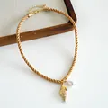 Detailed view of a gold-tone twisted cord necklace with a shell pendant and pearl - Brown Conch Style (HN12006) / Coffee Conch
