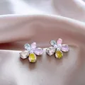 Vista dettagliata di eleganti orecchini a fiore con zirconi colorati e perle centrali - Ago d'Argento-Argento-Colorato