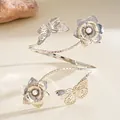 Elegant silver metal arm cuff featuring butterfly and flower designs with pearls - Silver