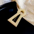 Detail view of a luxury keyhole-shaped brooch with sparkling pavé zircons - Full Rhinestone Keyhole Style (HP1010)