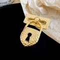 Detailed macro view of a vintage gold hammered metal padlock shaped brooch on dark background - Hammered Padlock Style (HP1010) / Gold-Black