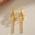 Elegant gold bow earrings with geometric pearl details and long metallic tassels - Gold Multi-Ring Intertwined Striped Tassel Style