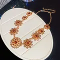 Elegant gold floral necklace with amber and pink rhinestones on a white display stand - Chain Only / Necklace-Gold-Brown