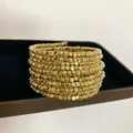 Close-up detail of multi-layer wrap bracelet with shiny golden geometric square beads - Style 46