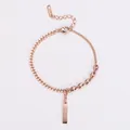 Detailed view of rose gold bracelet with minimalist gold bar pendant and pig nose links - Rose Gold