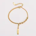 Close-up of gold bar bracelet with coffee bean links and 18KGP tag - Gold