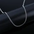 Detail shot of polished silver stainless steel curb chain links on a black stand - 06 Curb Chain Width 2mm / Length 40cm