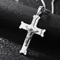 Macro shot of silver stainless steel crucifix pendant with detailed Jesus figure on ball chain - Steel