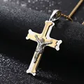 Close-up of stainless steel cross pendant with gold and silver tones and relief detail - Cross Pendant with Pearl Chain / Steel Gold