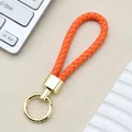 Portachiavi in pelle PU intrecciata arancione con anello a molla in metallo oro - Fibbia Intrecciata con Anello a Molla / Arancione