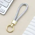 Portachiavi in pelle PU intrecciata argento con anello a molla e metallo dorato - Fibbia Intrecciata con Anello a Molla / Argento