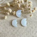 Light blue moon-shaped natural stone pendant with hand-carved face profile detail - Opalite