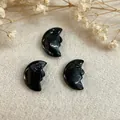 Handcrafted black obsidian crescent moon face pendant with detailed double-sided carving - Larvikite