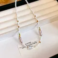 Elegante collana in acciaio inossidabile con perle di vetro bianche e accenti viola - 42# Collana-Oro-Bianco