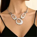 Silver chunky chain necklace with oversized polished links worn by a model in black - Silver Geometric Ring Necklace (8642)
