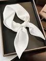 Minimalist plain white silk satin square scarf for women displayed on a dark tray - White