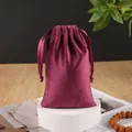 Elegant burgundy velvet drawstring jewelry pouch with silk ribbons on display stand - Burgundy