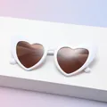 Chic oversized white heart-shaped sunglasses with brown lenses on a gradient background - C10