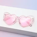 Pink heart-shaped sunglasses with glitter resin frame and Tribe logo on the lens - C11