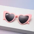 Pink heart-shaped sunglasses with dark lenses and BABE text on soft gradient background - Babe Pink Frame Gray Lens (C19)