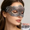 Detail of silver lace masquerade mask with intricate baroque patterns and ribbon ties - Stamped Silver