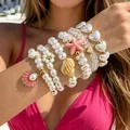 Stackable beaded bracelets with starfish, seashell charms and pearl accents - White Ocean Theme