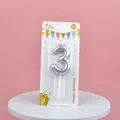 Detail view of silver balloon-style number 3 birthday candle in retail packaging. - Silver Number 3 Candle