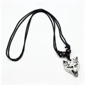 Close-up of wolf head resin pendant with faux bone carving texture and black cord - White
