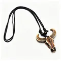 Close-up of resin buffalo skull pendant with ethnic totems and braided cord necklace - Brown