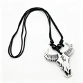 Close-up of retro resin buffalo skull pendant with ethnic carvings and black braided rope - White