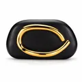 Close-up of black smooth leather clutch with golden sculptural metal closure - Black