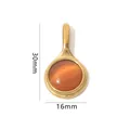 Detailed close-up of 30x16mm oval natural stone pendant with gold stainless steel frame - Gold Round Pendant - Orange Cat's Eye Stone