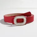 Close-up of red faux leather belt featuring a luxury pearl and rhinestone oval buckle - Red