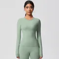 Detail of mint green yoga top showing thumbhole cuffs and stretchy brushed fabric - 7102 Long Sleeve - Basil Green / S
