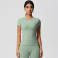 Front view of a light green yoga set featuring a short sleeve top and high waist leggings - 7103 Short Sleeve - Basil Green / S