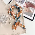 Floral print pleated scarf in orange and blue with silver pearl magnetic buckle - Turmeric