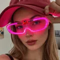 Neon pink LED glowing party glasses with large frames shown on a stylish female model - Square / Rose Red